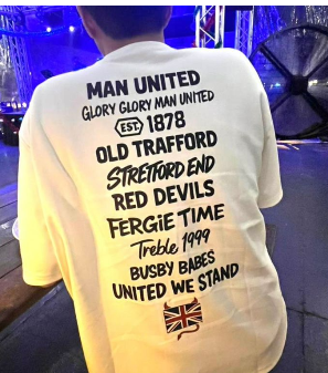 White t-shirt with black text with Perfect10 words on the back, worn by a person in an indoor setting.