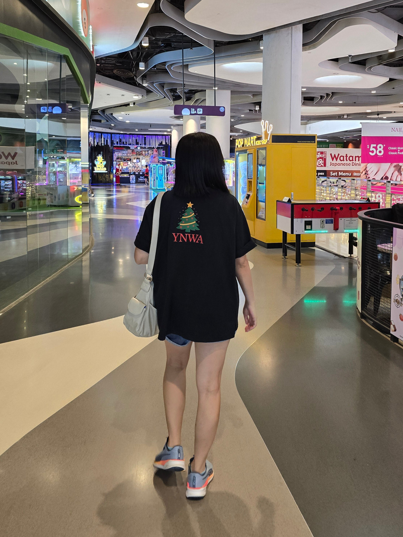 Person wearing Xmas Rock & Roll in shopping mall
