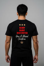 A man wearing a black King Santona T-shirt with Glory Glory at the back made by Unique for Fans