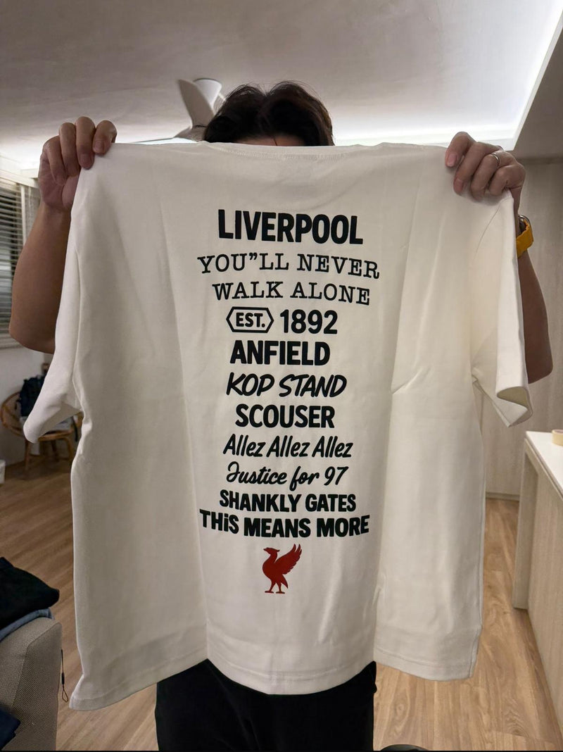 Person holding a white t-shirt with Perfect10 text