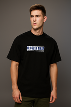 Man wearing a black t-shirt with 10852 on a gray background

