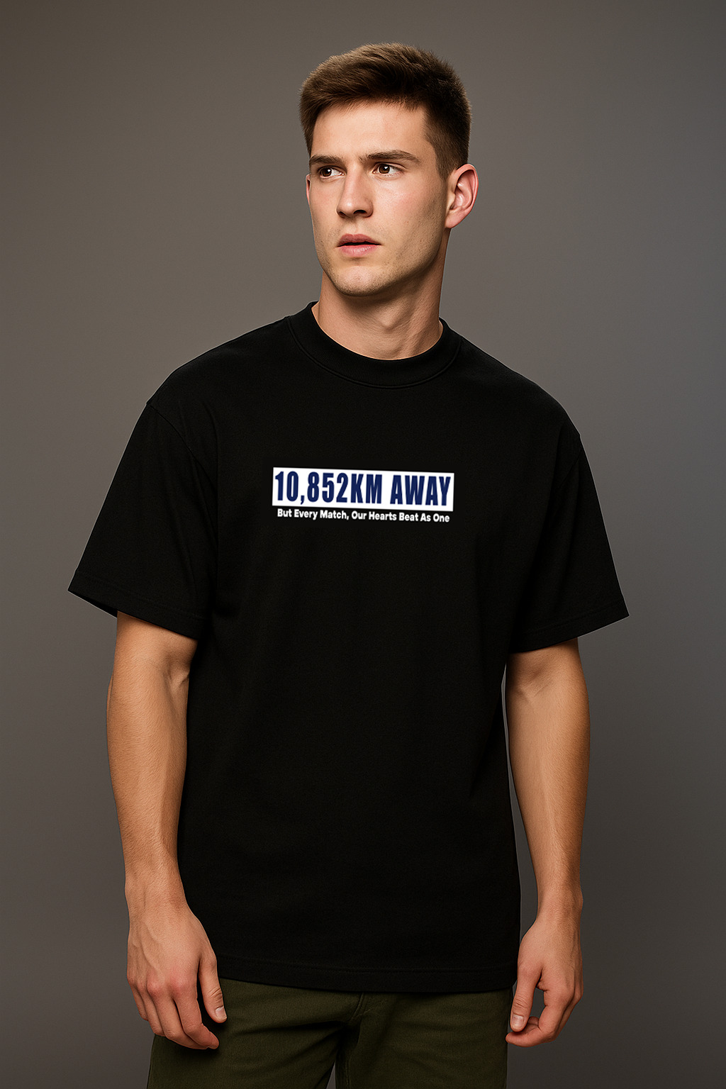 Man wearing a black t-shirt with 10852 on a gray background

